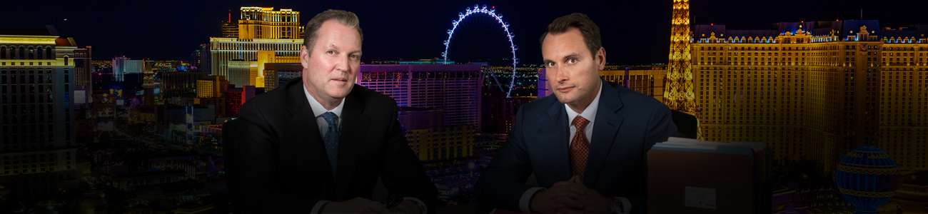 Bradley J. Hofland and Josh Tomsheck with Las Vegas skyline in the background.