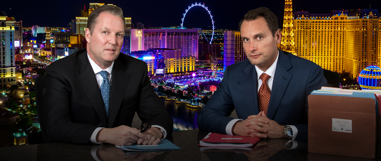 Bradley J. Hofland and Josh Tomsheck with Las Vegas skyline in the background.